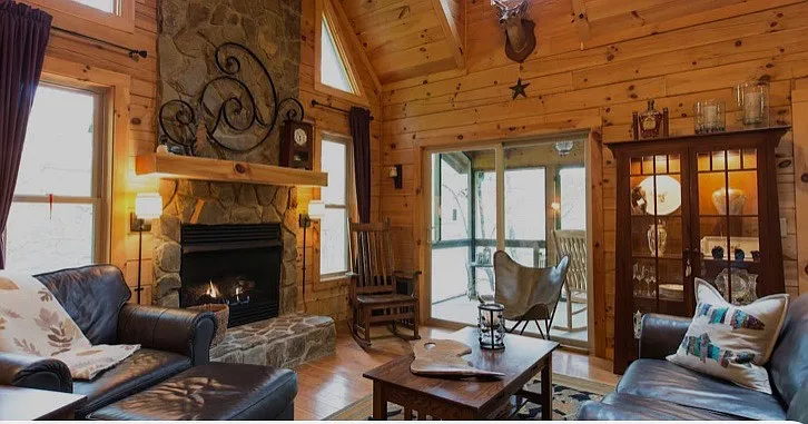 Great Room with gas fireplace, large skylight, bar. Doors lead to covered screened porch.