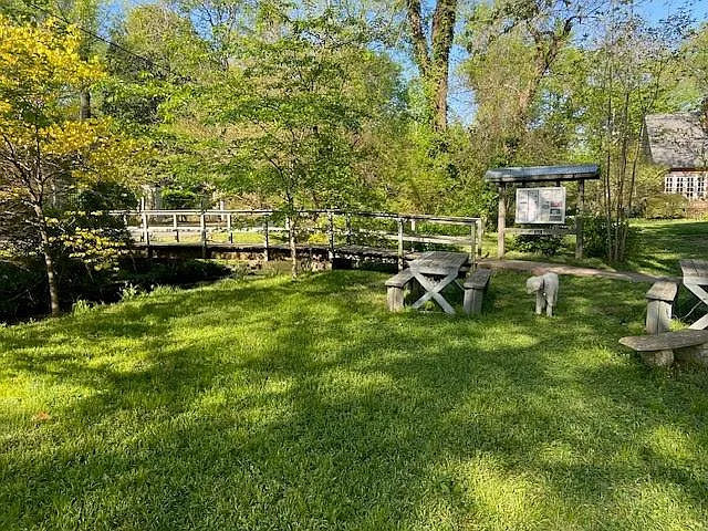 Walking bridge over creek and sitting area at end of dead-end street.