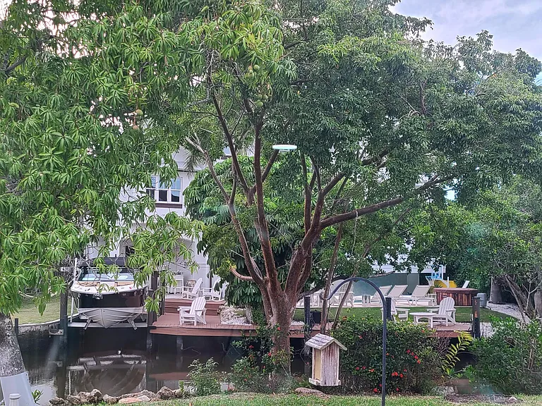 The view due west of the property; the neighbor directly accross the canal pic of the back yard