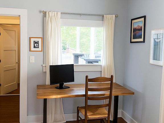 Gorgeous picture window overlooking porch, a WFH's dream