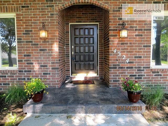 Inviting entry with beautifully stained door and tile floor.