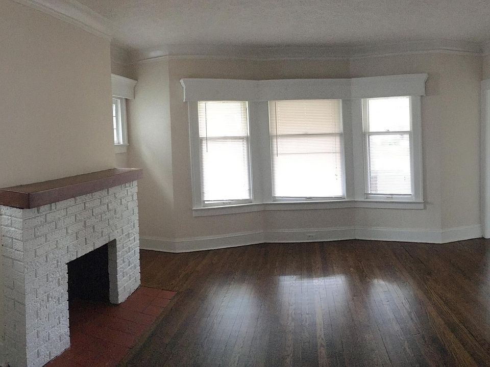 Beautiful living room with decorative fireplace and hardwood