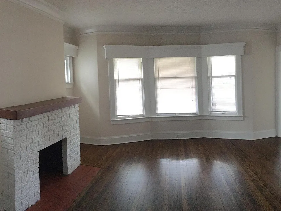 Beautiful living room with decorative fireplace and hardwood