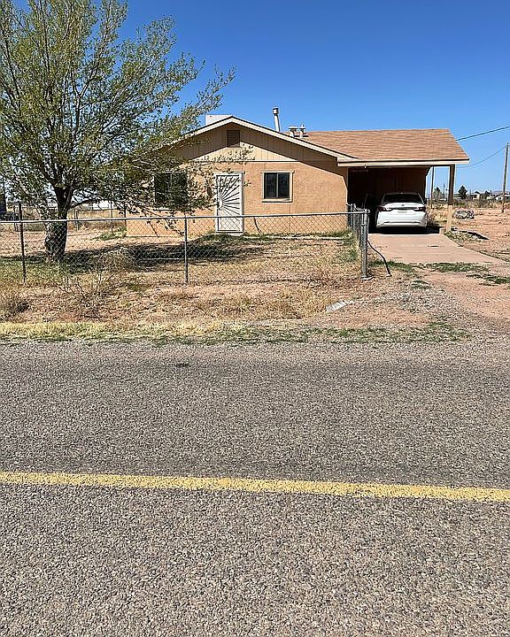 Street view facing North with fenced yard