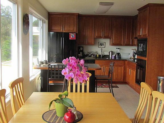 View into kitchen with built in micro wave, oven, and storage