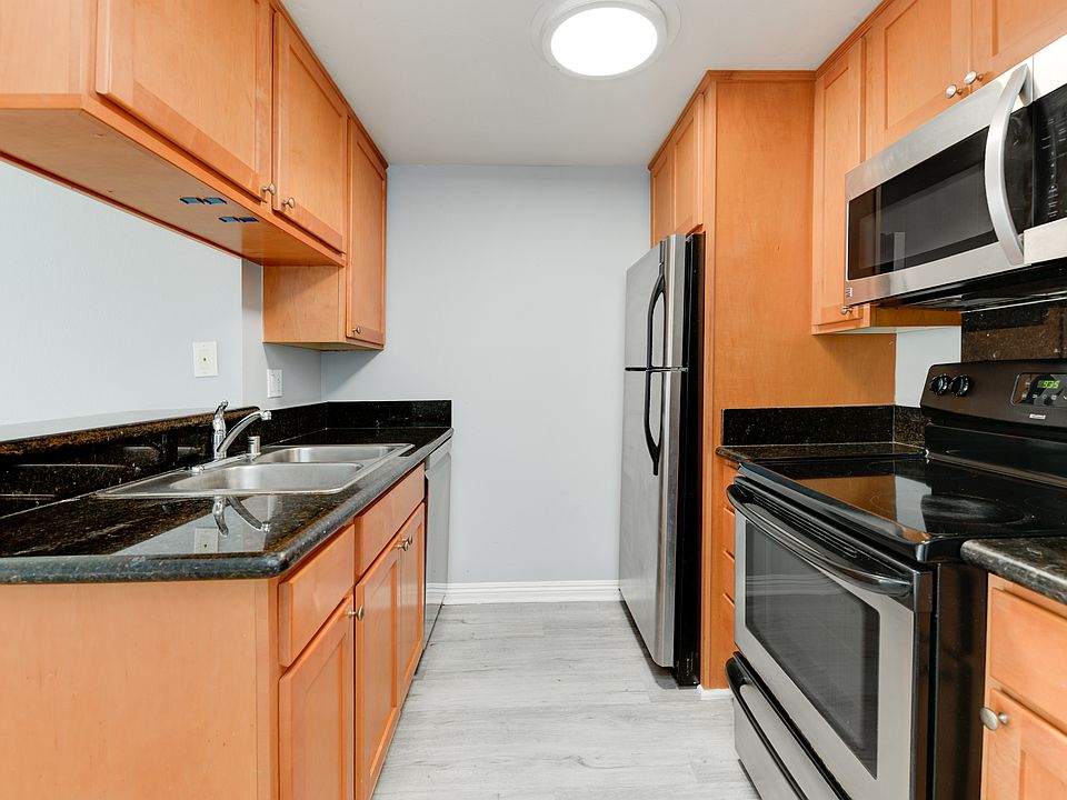Full kitchen. All cabinets are being refreshed with white paint and new black hardware.