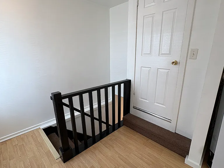 Top of stairs and entrance to bathroom.