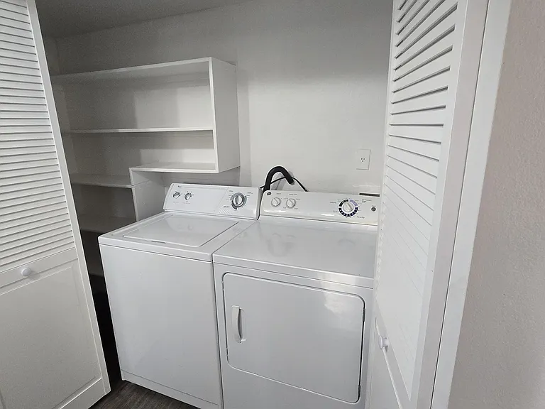 Inside laundry with washer/dryer included.