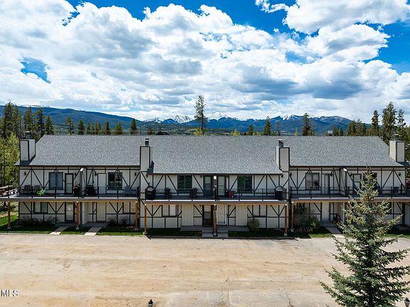 Aerial view of condo with parking lot