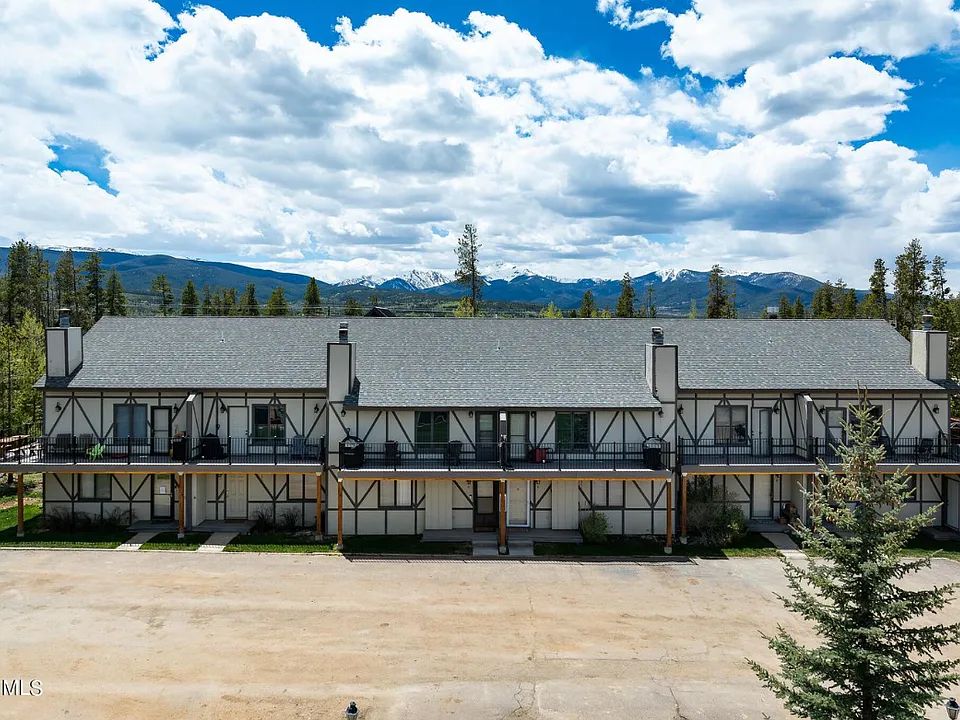 Aerial view of condo with parking lot