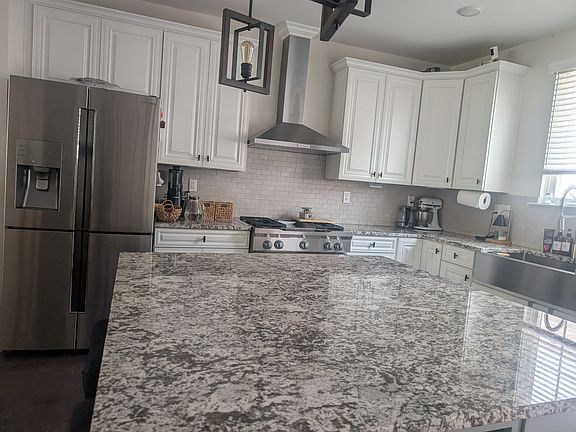 Kitchen Aid Chef's kitchen with an oversized granite island