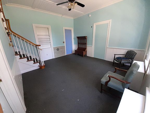 Large living room first floor, tall ceilings, big windows.