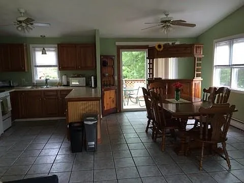 Top Level: Kitchen, Dining area, Stand-up bar unit and deck access. Kitchen fully equipped with cookware, utensils, glassware coffee maker and more.