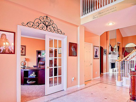 Two story entry marble floor foyer next to your French door enclosed office.