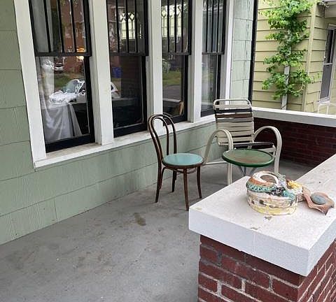 A cozy front porch for enjoying your favorite morning beverage.
