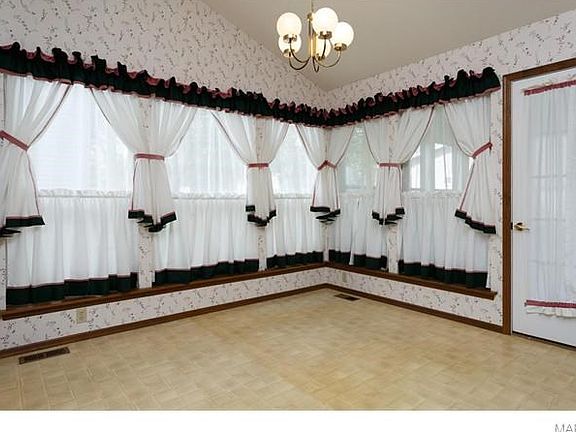 Formal living room with lots of windows and door to screen porch