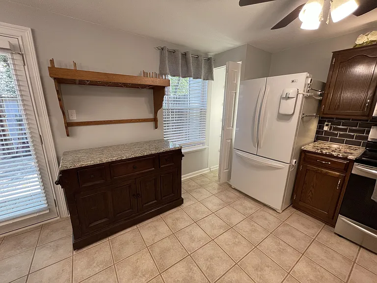 Kitchen with custom pot rack and center island relocated, pantry with bright linear lighting
