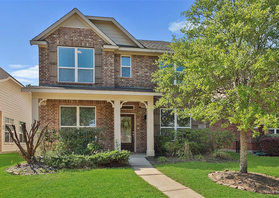 PRETTY CURB APPEAL: A front porch, accent shutters and a varied, gabled roof line provide welcoming curb appeal for this home in the master-planned community of Eagle Springs.