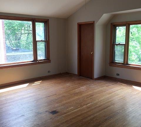 Front room, original oak floors, high ceiling, new ceiling fan with remote control.