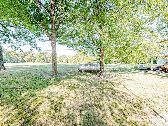 backyard with large oak trees and provides shade throughout the day