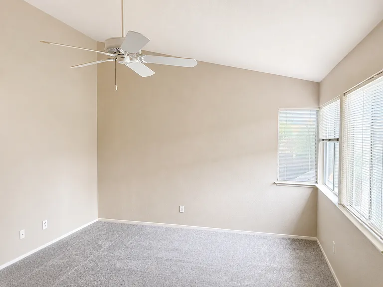 Spacious master bedroom with fan