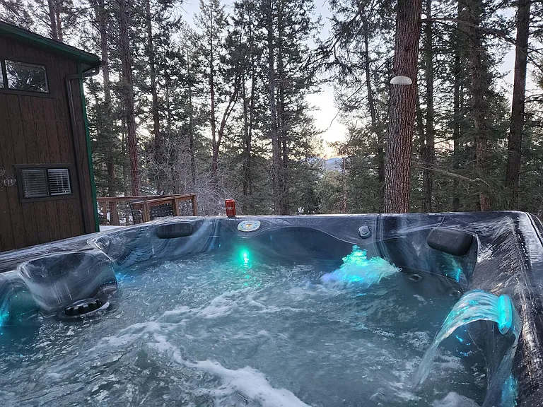 Jets, lights, tiny waterfall feature all make for a serene forest soak!