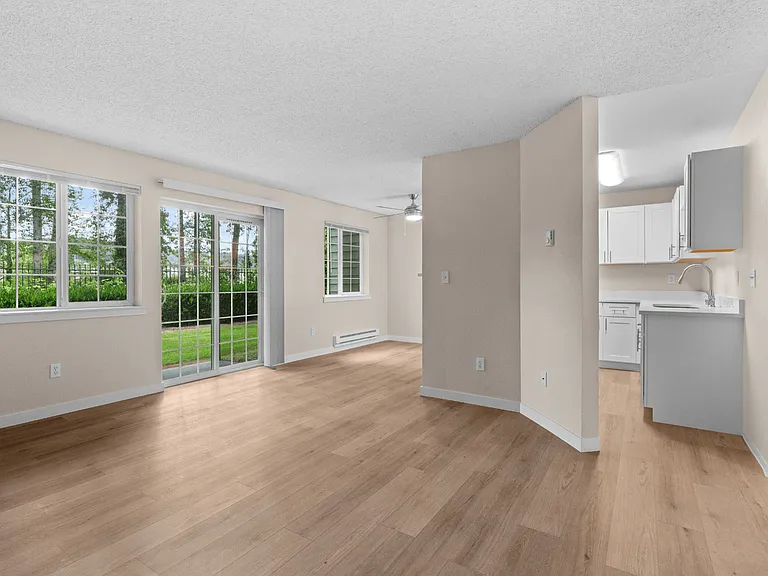 A light-filled dining space with large windows, direct patio access, and an open connection to the updated kitchen. A light-filled dining space with large windows, direct patio access, and an open connection to the updated kitchen.