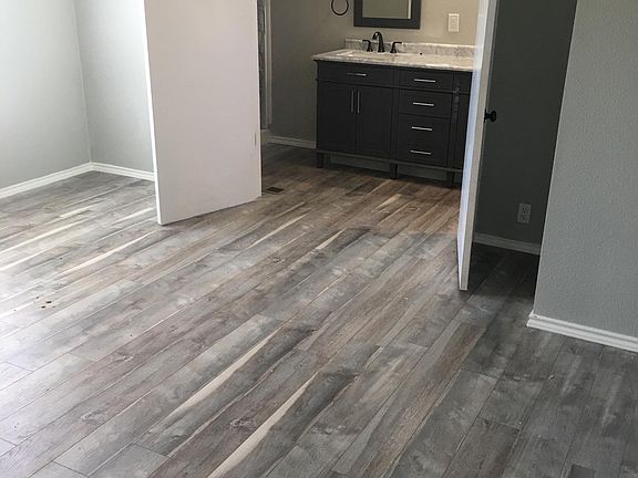 Master bedroom with double doors opening to the master bath. Spacious and beautiful new flooring