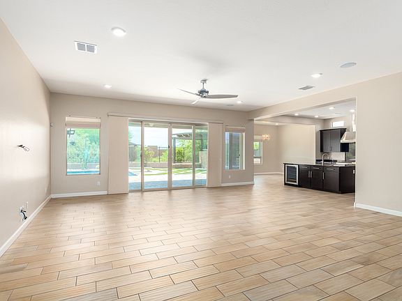 Open living space with sliding doors leading to the covered patio and sparkling pool with built in spa!