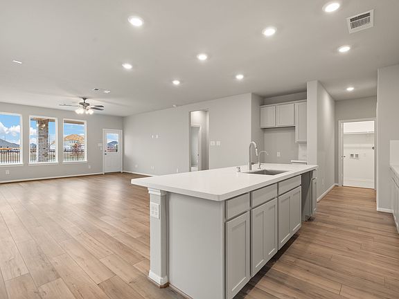 The kitchen features a center island that overlooks the large family and dining room.