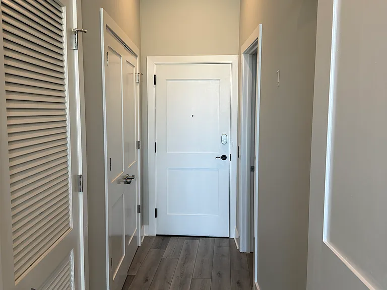 Entry hallway facing entrance door.