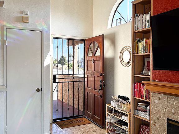 Front door, fireplace, mantel, coat closet, built-in book shelves