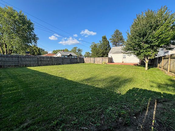 Large privacy fenced backyard facing towards the deck.