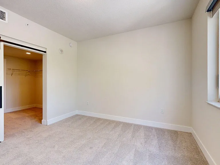 Spacious apartment Bedroom with Carpet Floor.