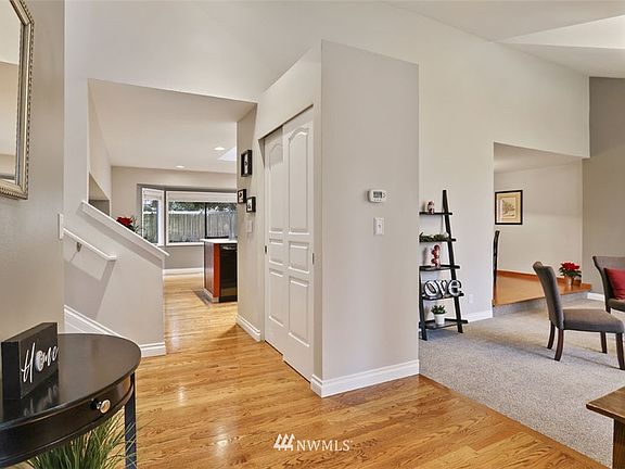 Cathedral ceiling, hard wood floors in endtryway and kitchen, new carpet. new paint, custom trim throughout.