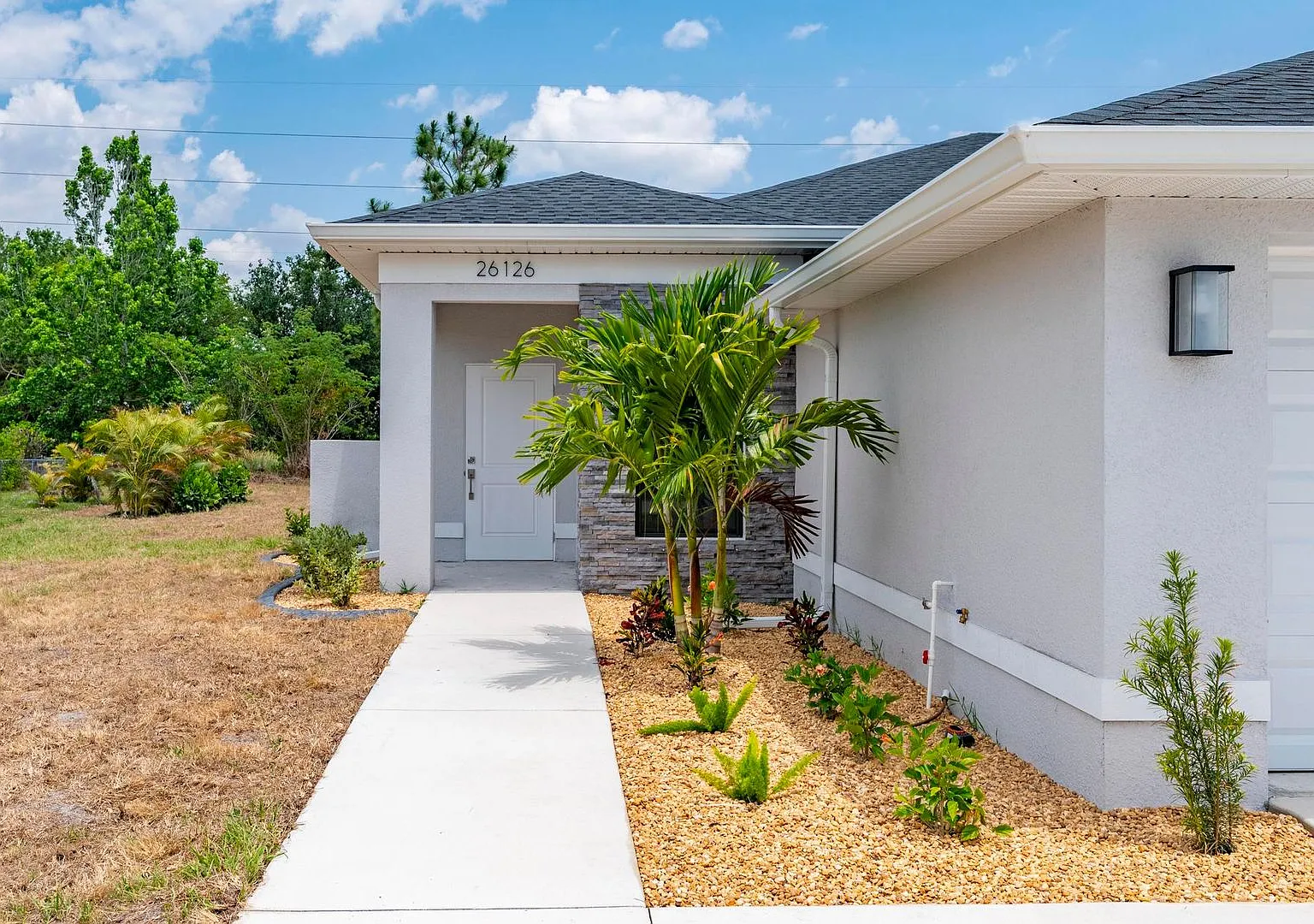 NEW Villa-duplex home with quartz counters, 2-car garage, and a rear patio — Photo 1