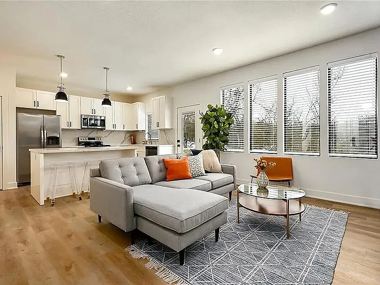 Bright and airy open-concept layout featuring oversized windows, modern cabinetry, stainless steel appliances, and luxury wood-style flooring throughout.

Photos are representative and finishes or layouts may vary slightly by unit.