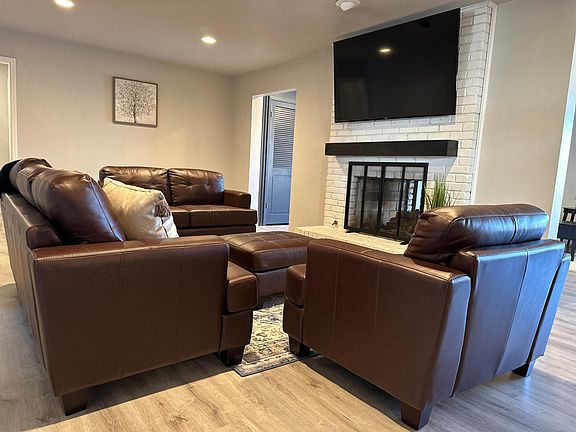 Main living room with 65 inch smart tv and gas fireplace