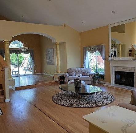 Open floorplan living room with newly polished hardwood floor.