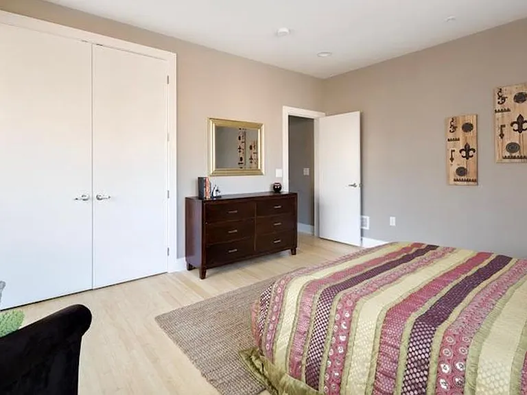 East bedroom with ample sunlight and plenty of storage