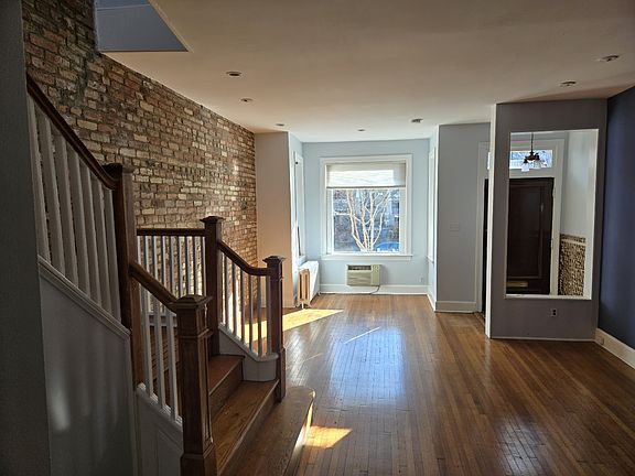 Living room and oak stairway.