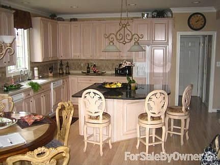 Kitchen with Spacious Granite Island
						:
						Appliances match the cabinetry . Tiled backsplash. Attaches to Breakfast Area