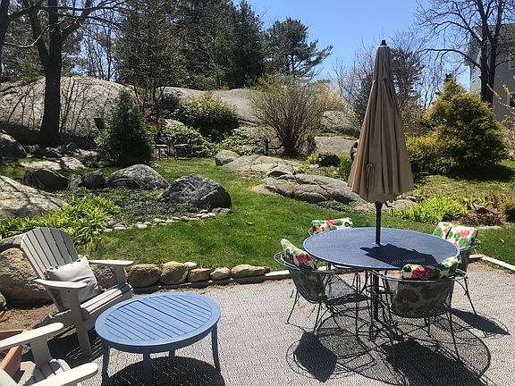 patio and back yard in winter with granite rocks