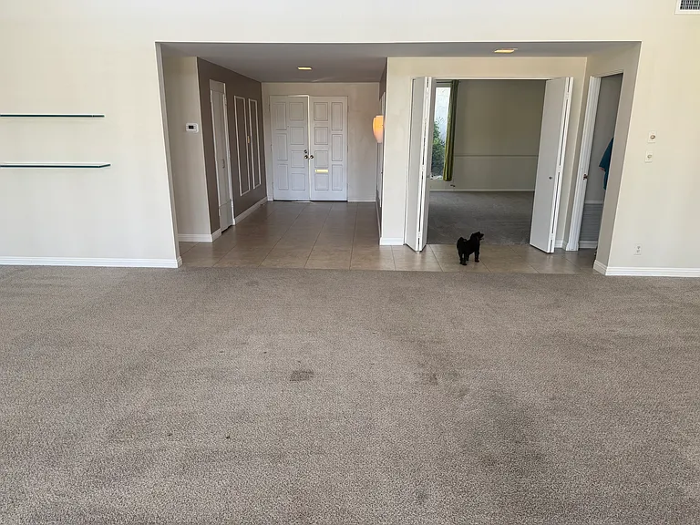 Living Room and Dining Area Looking Towards Front Door and entrance to third bedroom/office