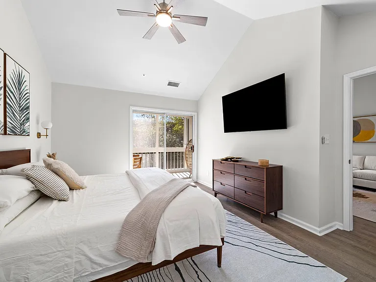 Vaulted ceiling in the primary bedroom with ceiling fan.