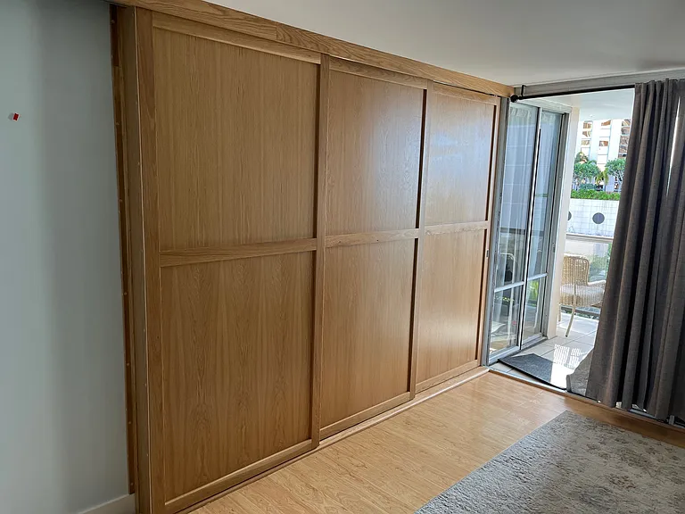 triple track sliding doors between living room and ocean view bedroom.