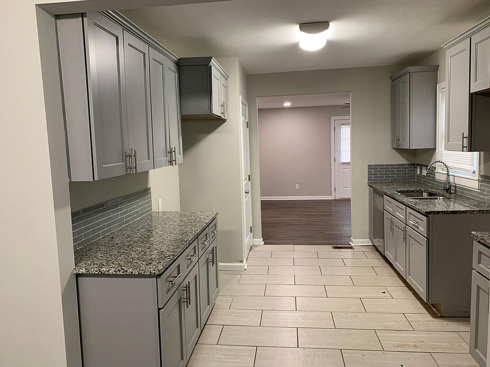 NEW CABINETS, GRANITE COUNTERTOP, UNDERMOUNT SINK, TILE FLOOR.
