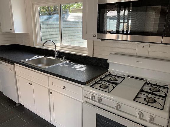 modern kitchen with granite countertops. Includes garbage disposal and microwave