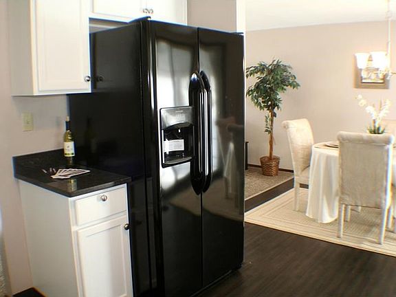 Kitchen looking into the dining room. New side-by-side refrigerator with in door ice and water. More