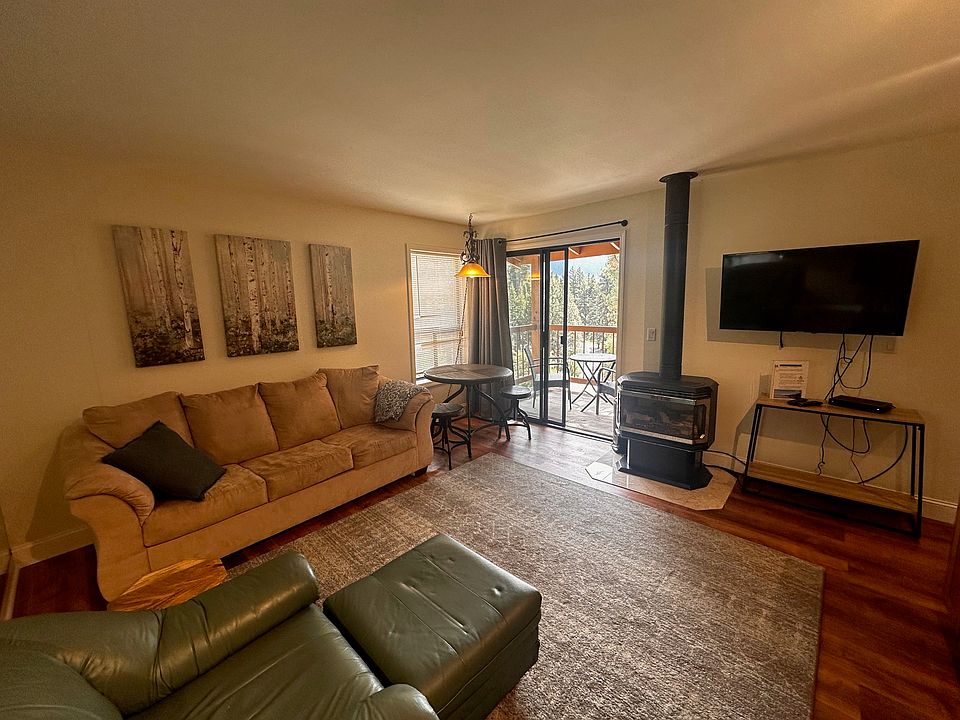 Living Area with pull-out sofa, access to exterior deck.